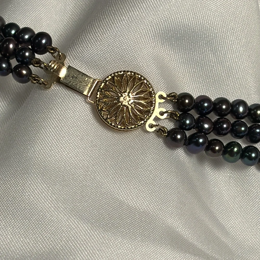 Tahitian black pearl bracelet with 14k gold filigree clasp.